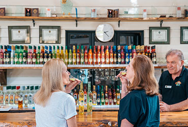 Two women enjoying a tasting at the Tamborine Mountain Distillery