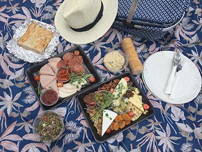 Contents of Picnic Hamper laid out on colourful cloth