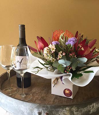 Bunch of flowers and bottle of wine displayed
